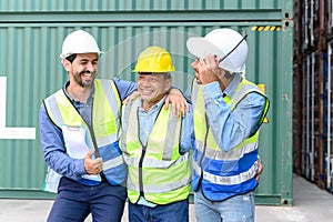 Group of happy professional engineers and foreman container cargo wearing yellow hardhat and safety vests checking stock into