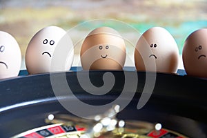 Group of happy and sad eggs friends  make bets gambiling at the toy roulette in the toy casino