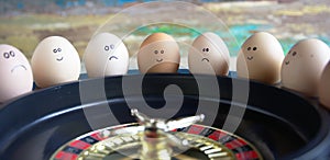 Group of happy and sad eggs friends  make bets gambiling at the toy roulette in the toy casino