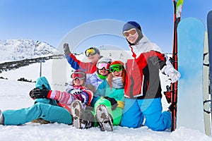 Group of happy snowboarders in the mountains