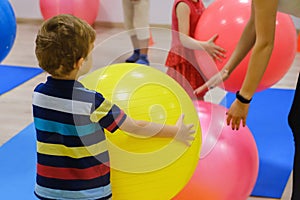 Group of Happy sporty children`s exercise with ball, fitness gym.