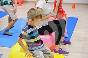 Group of Happy sporty children`s exercise with ball, fitness gym