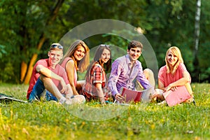 Group of happy students with books in the Park