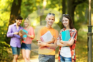 Group of happy students with books in the Park