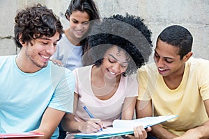 Group of happy students learning outdoors on campus