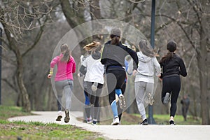 Group of happy teenage friends or sportsmen running marathon