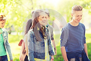 Group of happy teenage students walking outdoors
