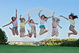 Group of happy teens jumping,