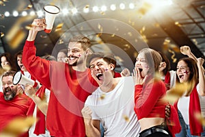 Group of happy thrilled excited soccer football fans cheering for their sport team victory. Concept of emotions, global