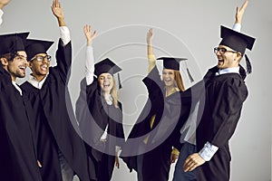 Group of happy university students celebrating graduation and having fun together