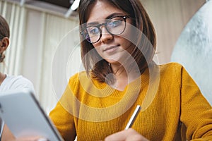 Group of happy woman working together and using digital gadgets at open space