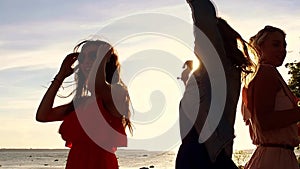 Group of happy women or girls dancing on beach 38
