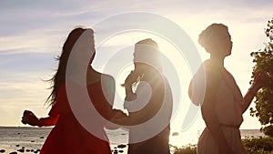 Group of happy women or girls dancing on beach 40