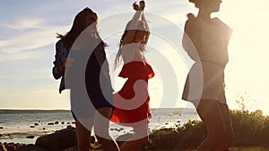 Group of happy women or girls dancing on beach 51