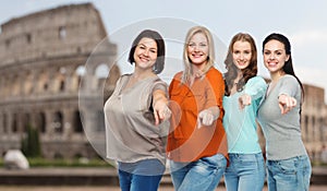 Group of happy women pointing finger over coliseum