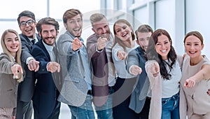 Group of happy young business people pointing at you