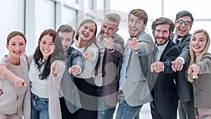 group of happy young business people pointing at you