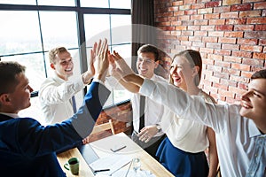 Group of happy young business team celebrating.