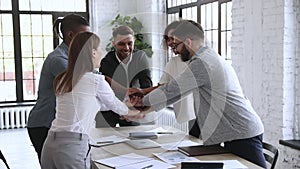 Group of happy young diverse managers building successful team cooperation.