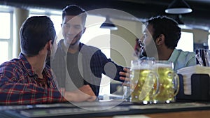 Group of happy young friends drinking beer