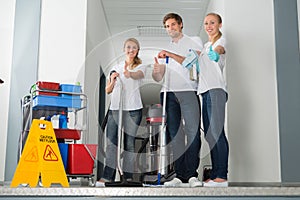 Group Of Happy Young Janitor Showing Thumbs Up