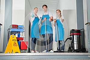 Group Of Happy Young Janitor Showing Thumbs Up