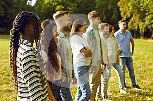 Group of happy young multiethnic men and women at an outdoor workshop in the summer