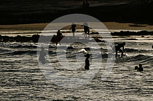 group of happy young people at the beach