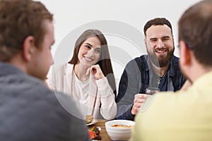 Group of happy young people at dinner table, friends party