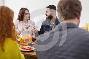 Group of happy young people at dinner table, friends party