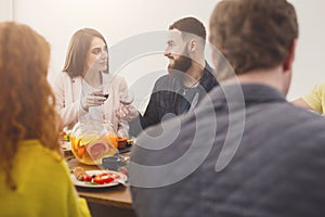 Group of happy young people at dinner table, friends party