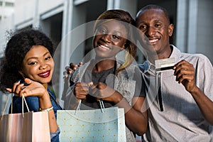 Group of happy young people doing shopping together