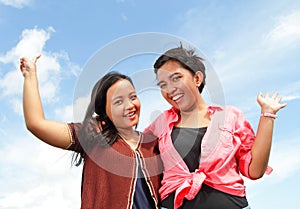 Group of happy young people with hands up