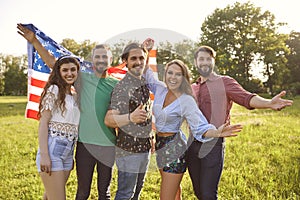 A group of happy young people have fun celebrating America`s Independence Day.