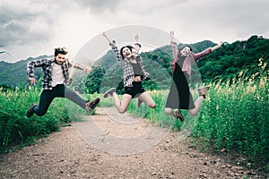 Group of happy young people jumping in the air.