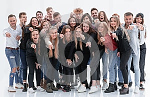 Group of happy young people pointing at you