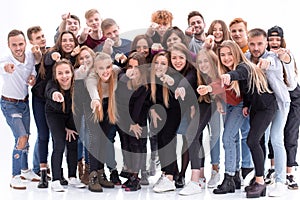 Group of happy young people pointing at you