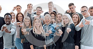 Group of happy young people pointing at you.