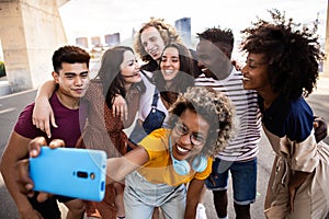 Group of happy young people taking selfie together on summer vacation
