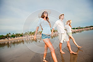 Group of happy young people walking along the