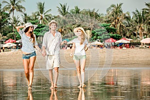 Group of happy young people walking along the