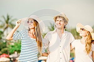 Group of happy young people walking along the