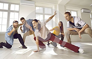Group of happy young street dancers having fun while dancing together in a studio
