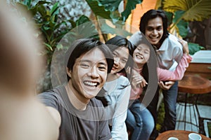 Group of happy young teenager students taking selfie photo