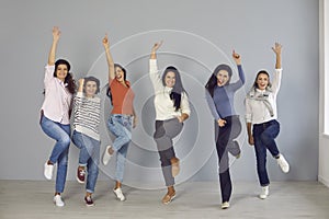 Group of happy young women jumping for joy and laughing, celebrating team success
