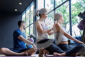 A group of health-loving people are practicing yoga with experienced teachers.
