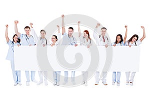 Group of healthcare personnel holding a banner