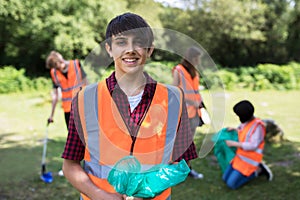 Group Of Helpful Teenagers Collecting Litter In Countryside