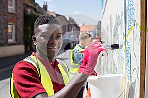 Group Of Helpful Teenagers Creating And Maintaining Community Ar