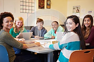 Group Of High School Students In Class Using Laptops